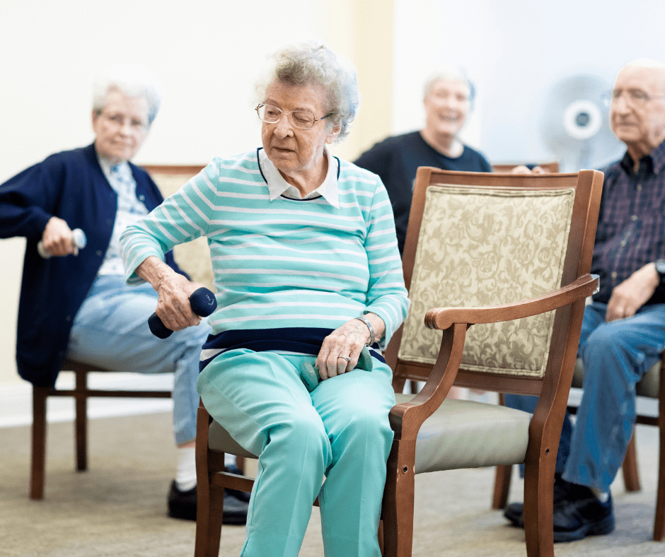 Seniors engaged in a lively seated exercise class, using hand weights, promoting wellness and community connection.