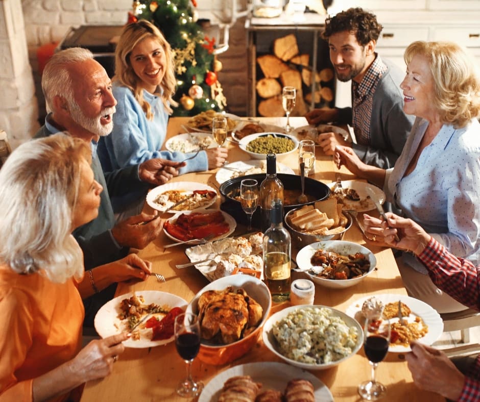 A joyful group enjoys a festive meal together, surrounded by delicious dishes and a warm, inviting atmosphere.