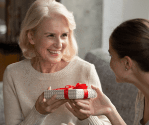 Adult daughter giving her mother a present