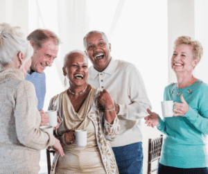 Group of residents laughing and enjoying coffee