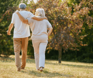 Senior couple walking with arms around each other