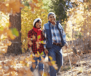 9-4-24 - Grace Management Couple walking in the woods during autumn