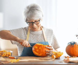 10-23-24 - Grace Management Woman carving a pumpkin