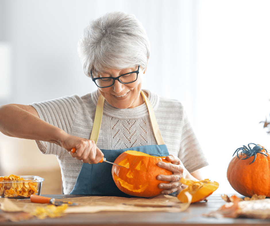 Woman carving a pumpkin