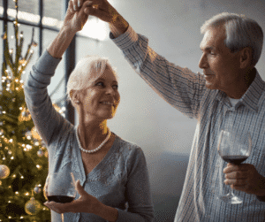 11-20-24 - Grace Management Couple dancing in front of Christmas tree