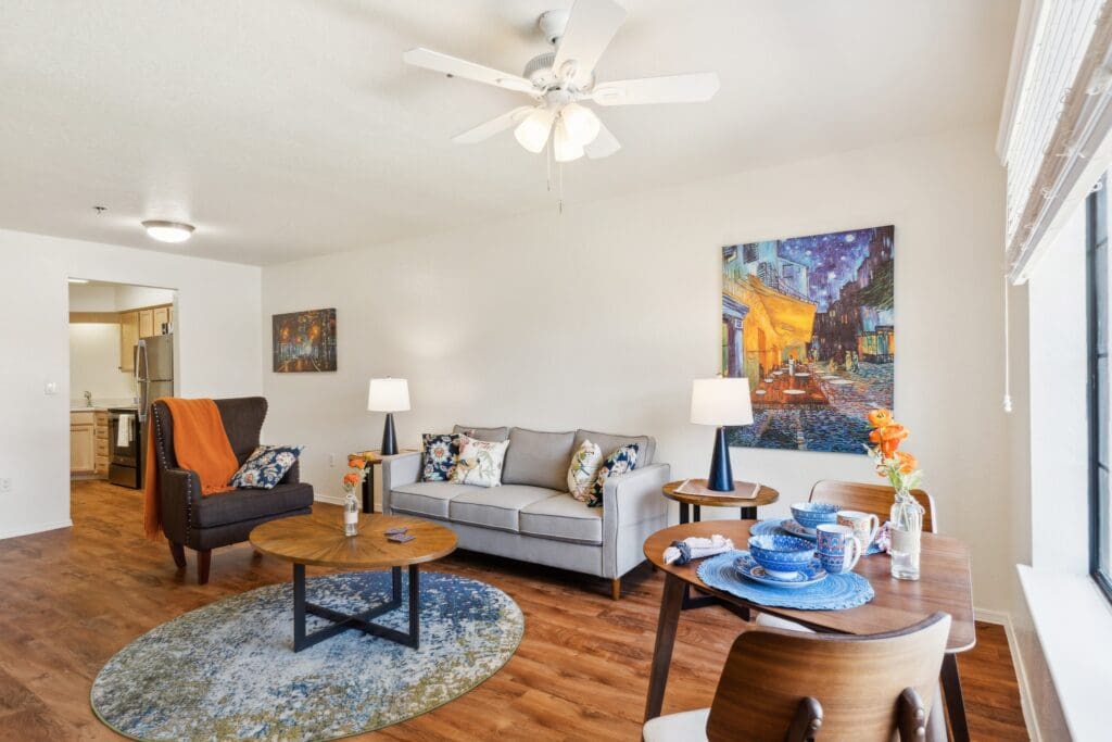 Bright, inviting living space featuring elegant decor, comfortable seating, and a dining area, enhanced by natural light.