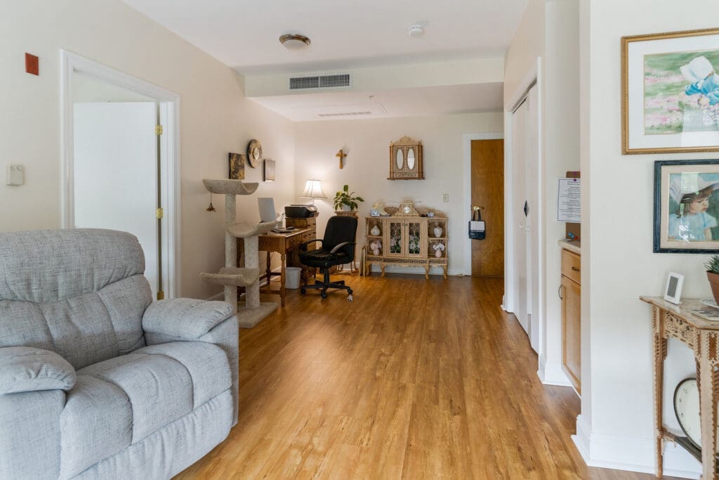 Spacious living area featuring comfortable seating, a workspace, and elegant decor, promoting a vibrant lifestyle.