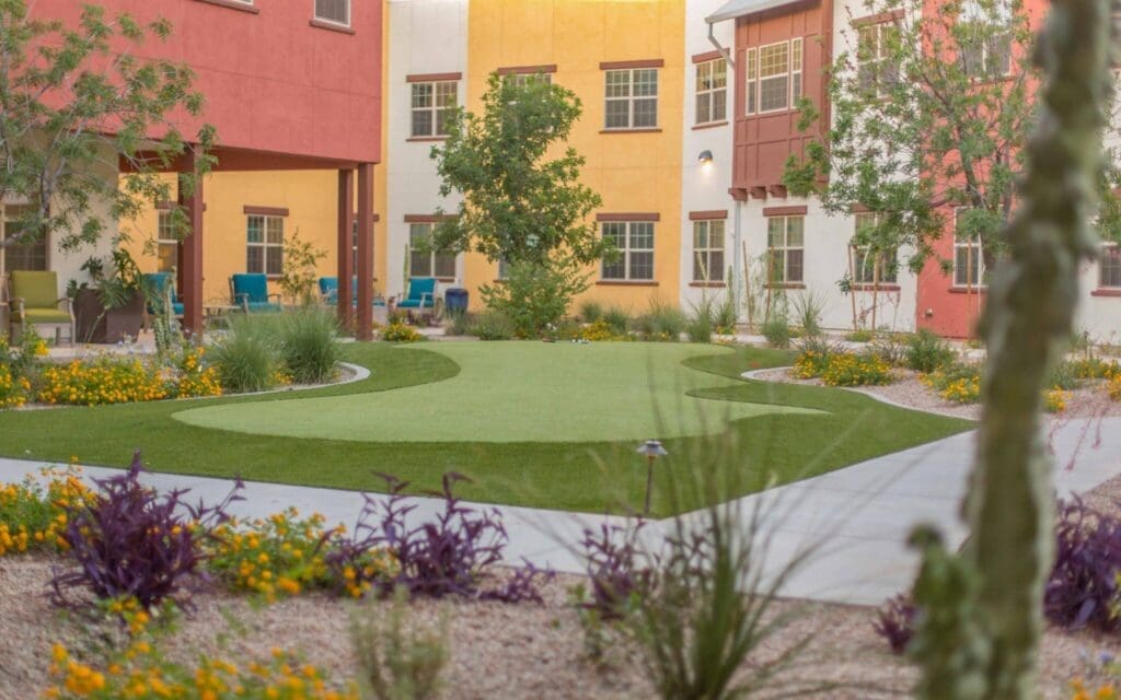 Sage-Desert-Tucson-AZ-2018-June-0898-2048x1280 - Grace Management Vibrant courtyard featuring lush landscaping, colorful flowers, and upscale seating areas for a welcoming community atmosphere.