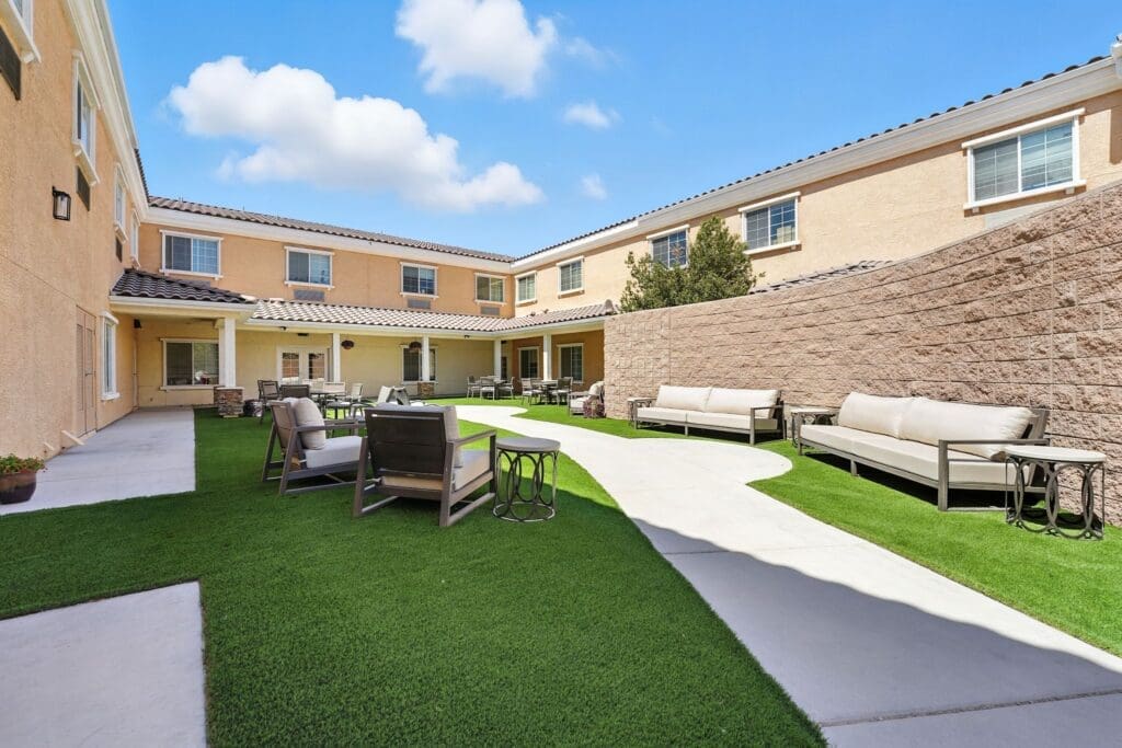 Inviting outdoor courtyard featuring plush seating and lush greenery, perfect for socializing and relaxation.