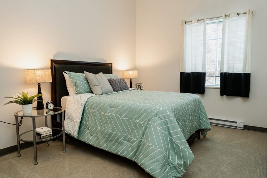 Cozy bedroom featuring a stylish bed, elegant lighting, and a nurturing ambiance with modern decor and natural elements.