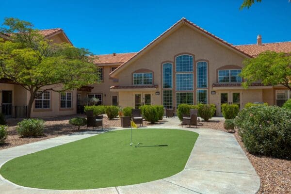 Interior image of a Vista Pointe at Green Valley apartment with a living room, dining area, and peek into the bedroom.