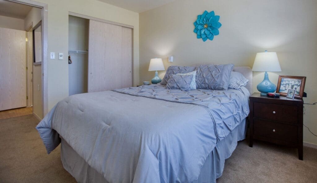 Inviting bedroom featuring a plush bed, soft lighting, and tasteful decor, creating a serene, cozy atmosphere.