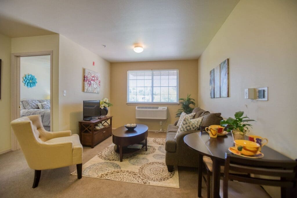 Inviting living room with cozy seating, vibrant decor, and a warm atmosphere, showcasing a bright and welcoming space.