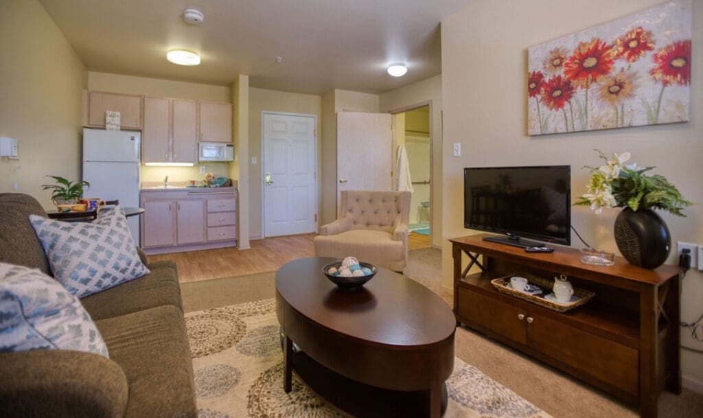 Charming living area features a sofa, cozy chair, kitchenette, and vibrant decor, exemplifying an inviting, upscale atmosphere.