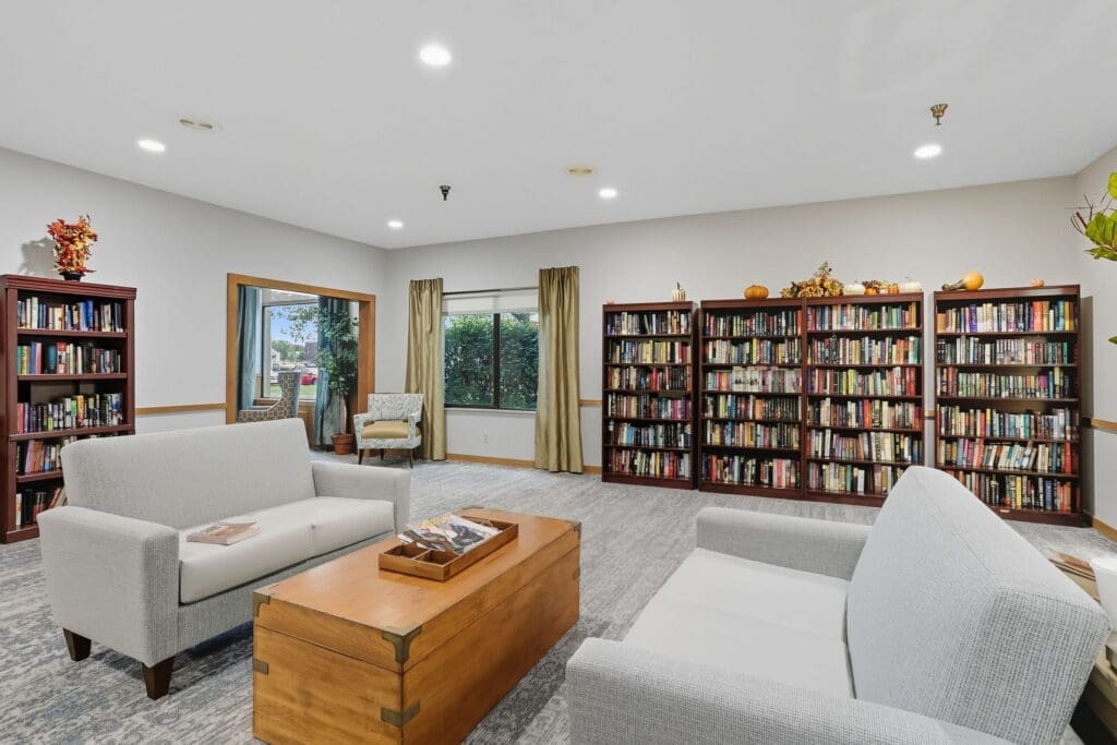 Lively reading area with cozy seating, bookshelves filled with books, and warm decor, fostering a vibrant community atmosphere.
