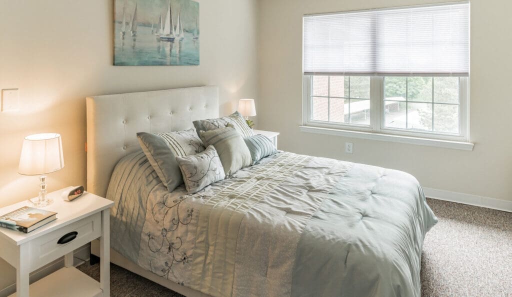 Inviting bedroom featuring a plush bed, elegant decor, soft lighting, and a soothing color palette, promoting restful living.