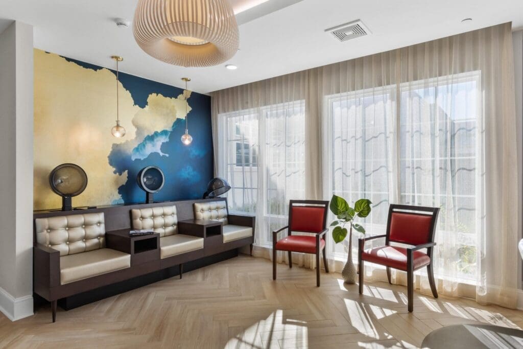 184-2048x1365 - Grace Management Stylish seating area with elegant décor, large windows, and inviting lighting, creating a warm, vibrant atmosphere.