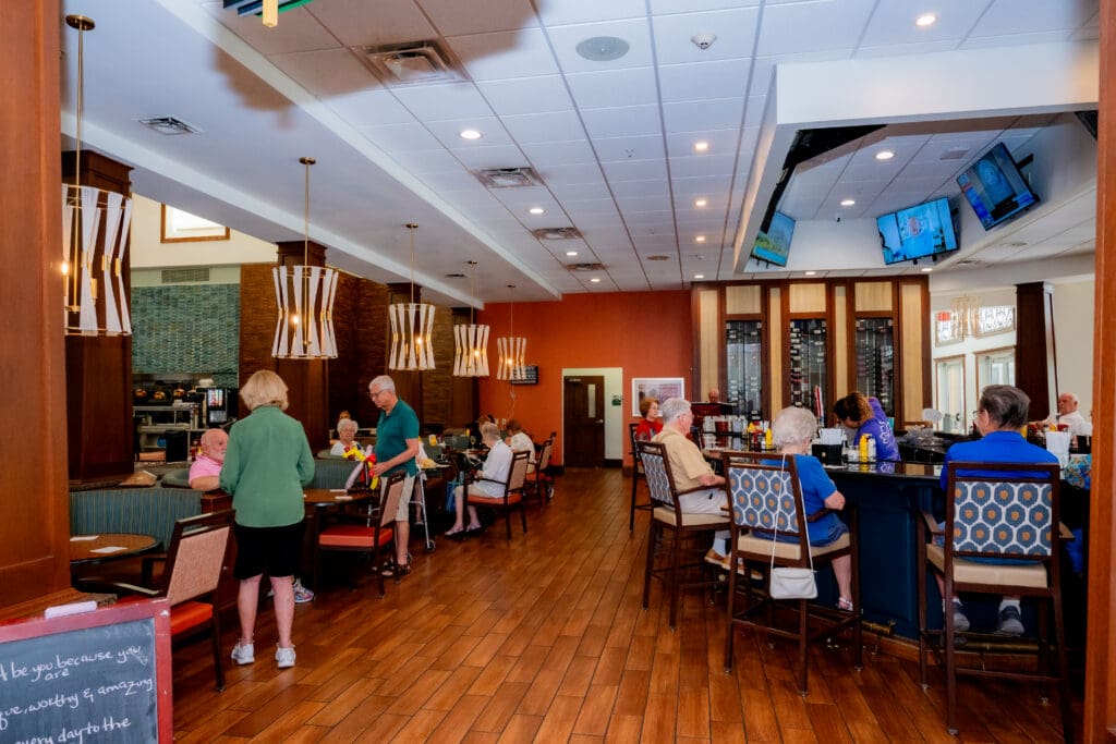 Inviting dining area in senior living community, where residents enjoy meals and socialize in a warm, vibrant atmosphere.