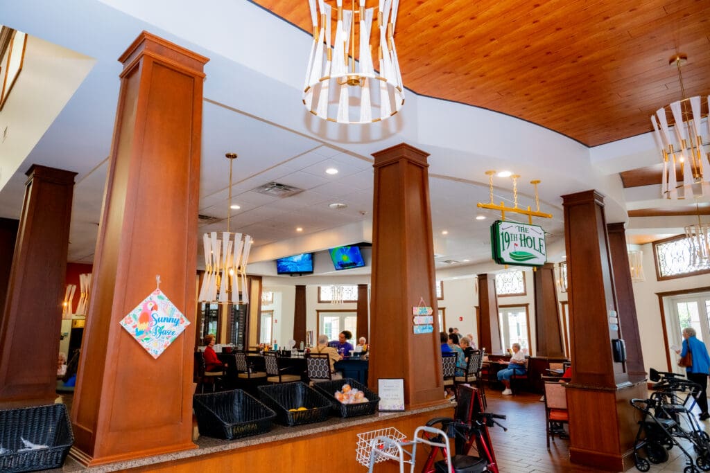 Upscale dining area featuring a warm ambiance, residents socializing, and elegant decor, promoting a vibrant community lifestyle.