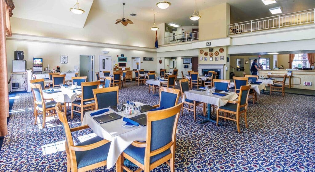 2022_LakeHavasu_INT-dining_30-scaled - Grace Management Spacious dining area with elegant tables set for meals, showcasing a welcoming atmosphere for social dining experiences.