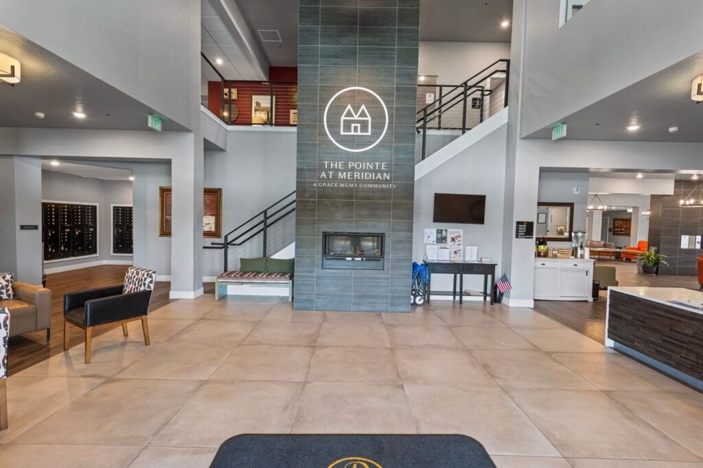 Stylish lobby of The Pointe at Meridian, featuring modern decor, comfortable seating, and a welcoming fireplace.
