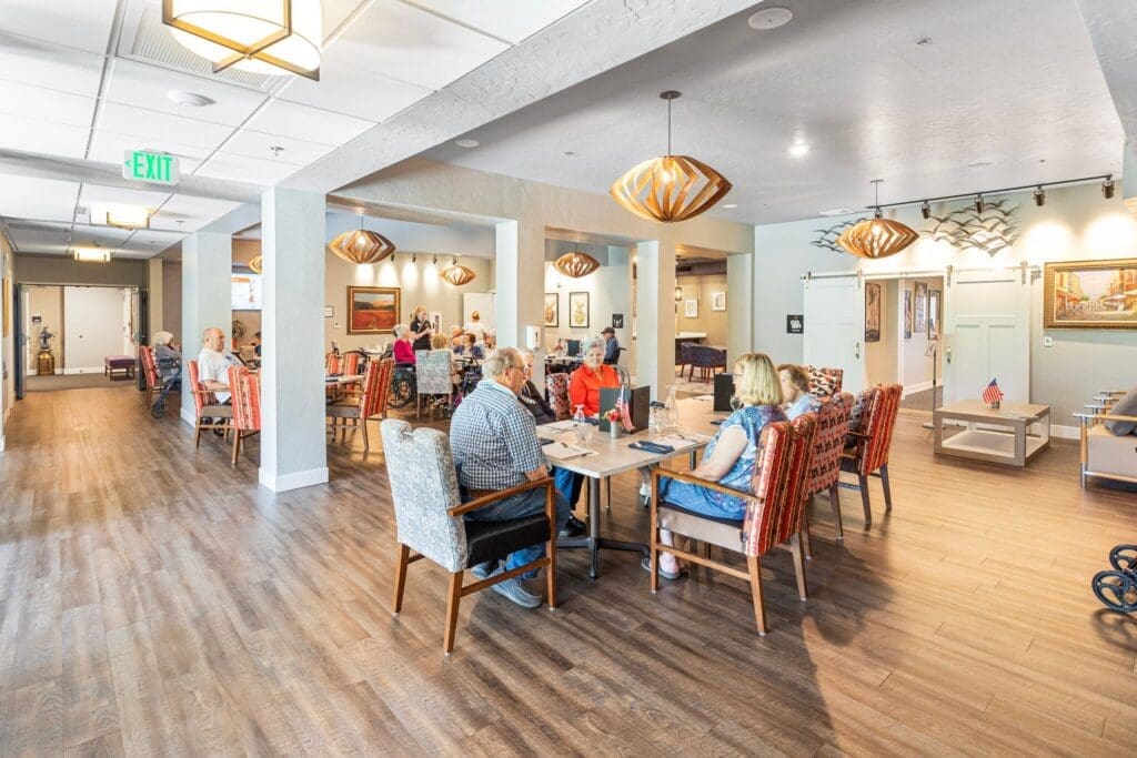 Elegant dining area filled with residents enjoying meals, vibrant decor, and welcoming ambiance, promoting a lively community atmosphere.