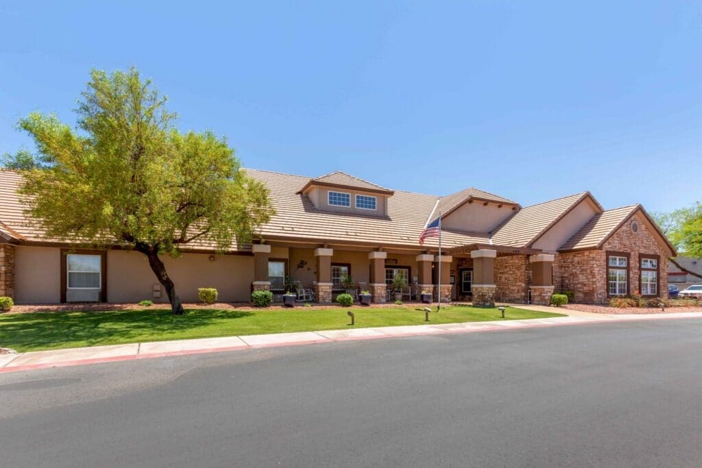 Inviting senior living community exterior with lush landscaping and a welcoming entrance, promoting an active lifestyle.