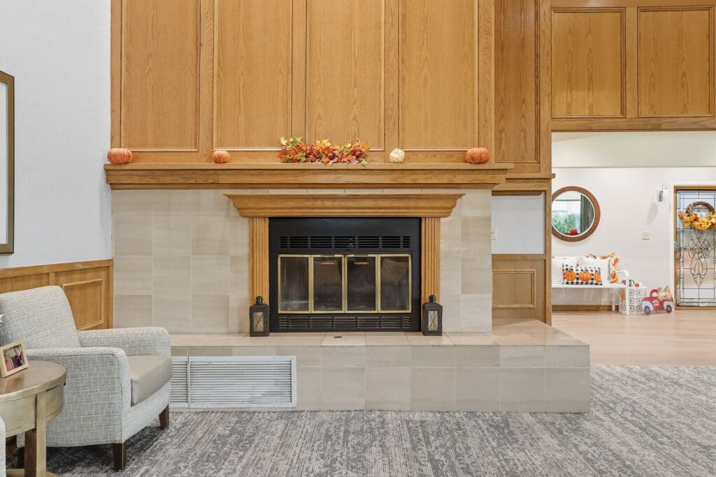 Inviting lounge area featuring a warm fireplace, seasonal decor, and cozy seating, promoting a vibrant community atmosphere.