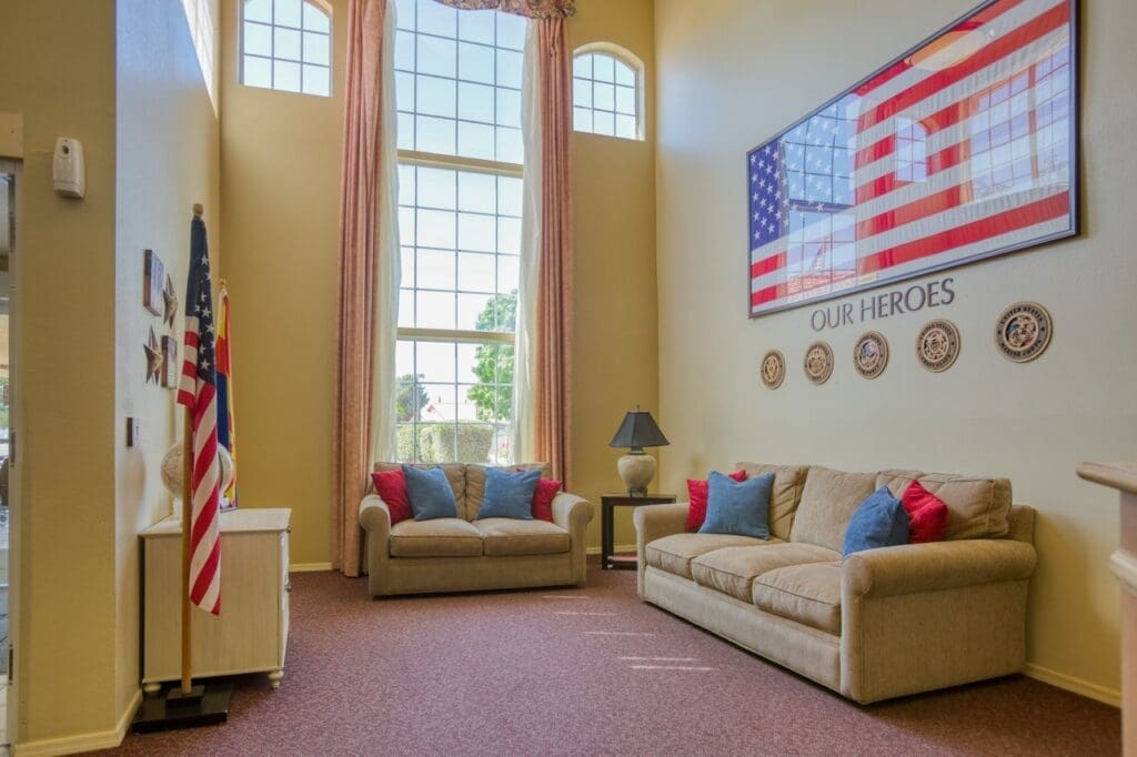 Inviting lounge area with cozy sofas, large windows, and patriotic decor, offering a warm and welcoming atmosphere.