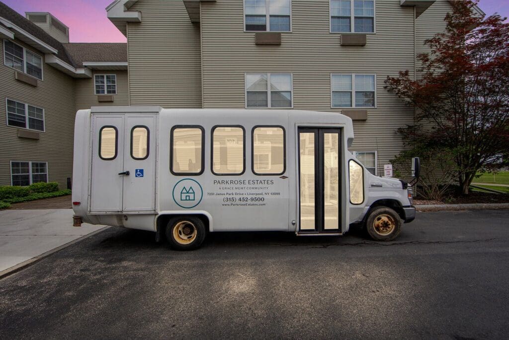 Accessible transportation shuttle parked outside Parkrose Estates, showcasing the welcoming community environment.