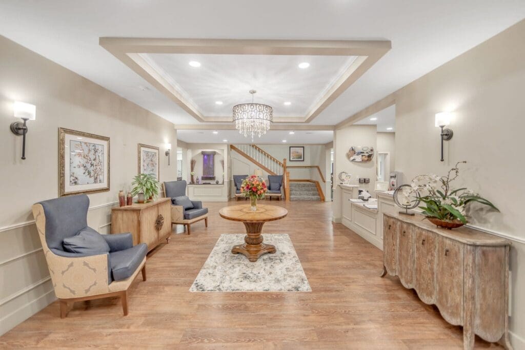 Inviting foyer featuring elegant decor, cozy seating, and a large wooden table, ideal for social gatherings.
