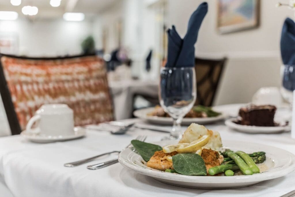 Elegant dining setting featuring a gourmet meal of salmon, asparagus, and lemon, with upscale dining amenities.