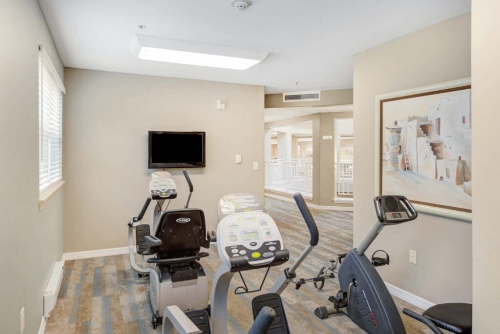 Well-appointed fitness area featuring recumbent exercise bikes and a television, promoting an active, vibrant lifestyle.