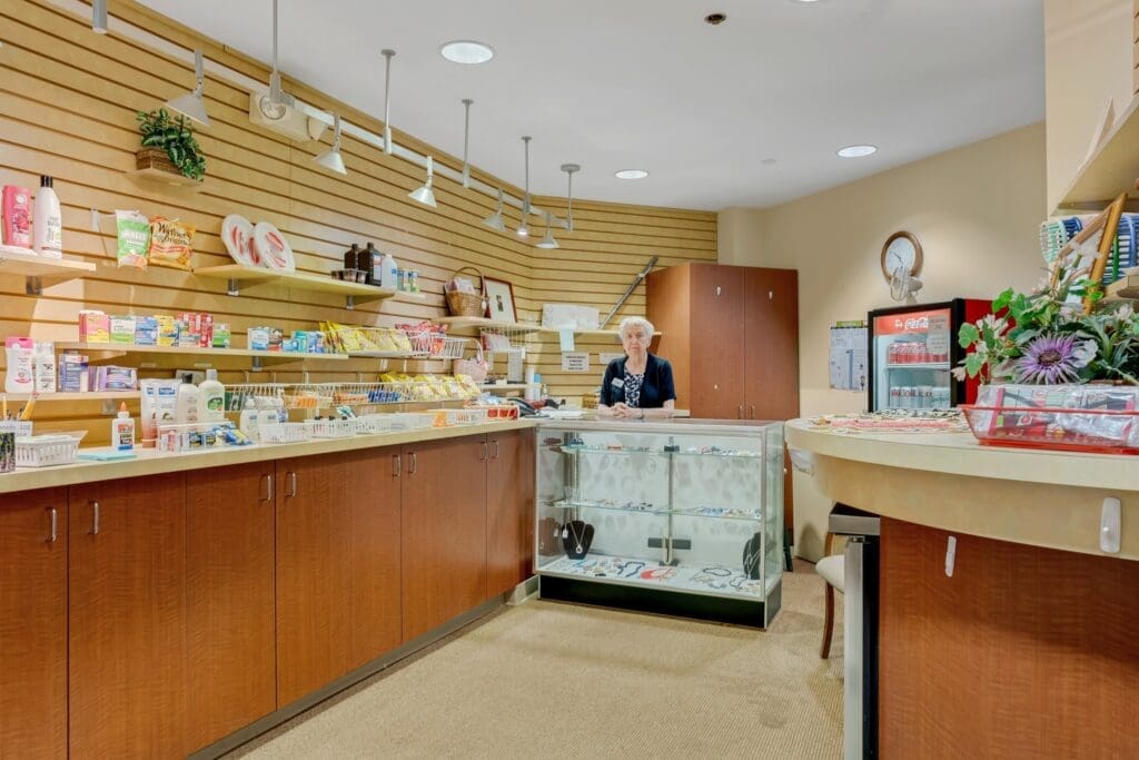 Well-stocked retail space with a friendly staff member at the counter, offering various products in an inviting setting.