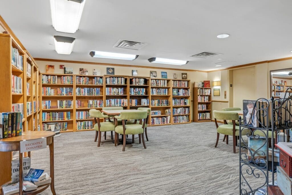 Warm and inviting library with wooden shelves filled with books, cozy seating, and bright lighting for a vibrant reading experience.