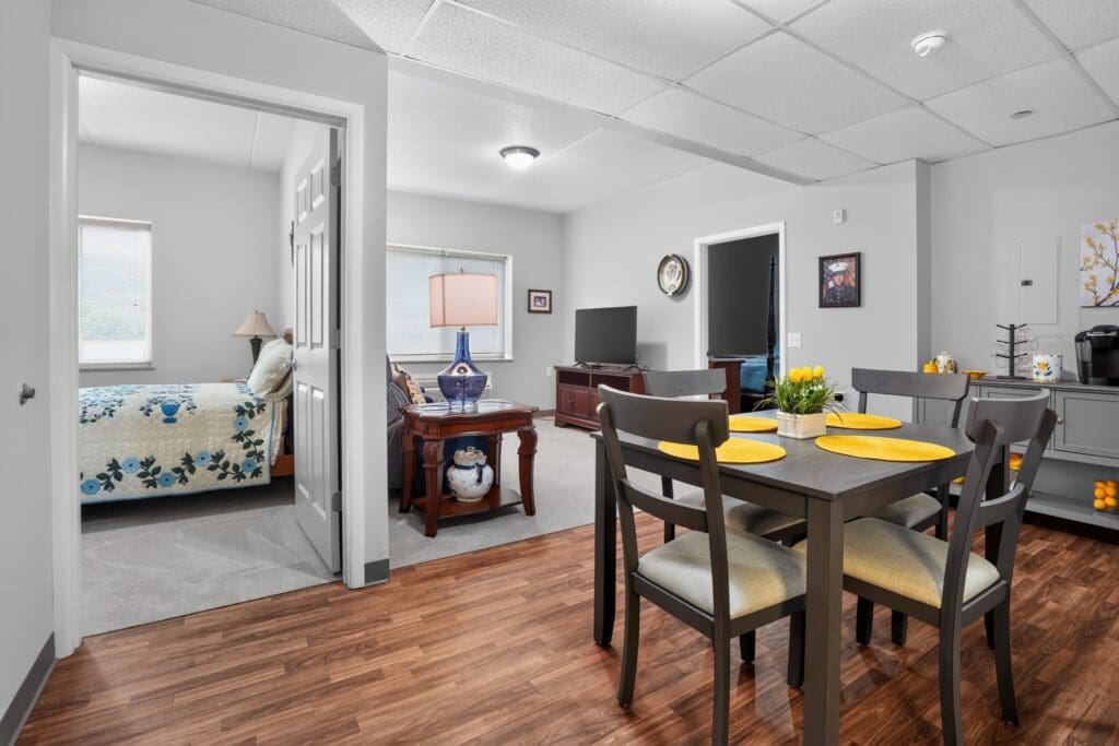 Stylish senior living space featuring a cozy dining area, a welcoming living room, and a serene bedroom.