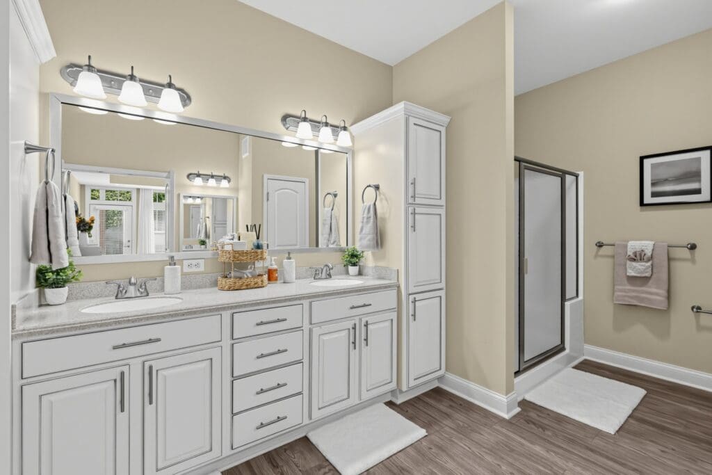 Elegant, spacious bathroom featuring a double vanity, modern fixtures, and bright lighting for an upscale living environment.
