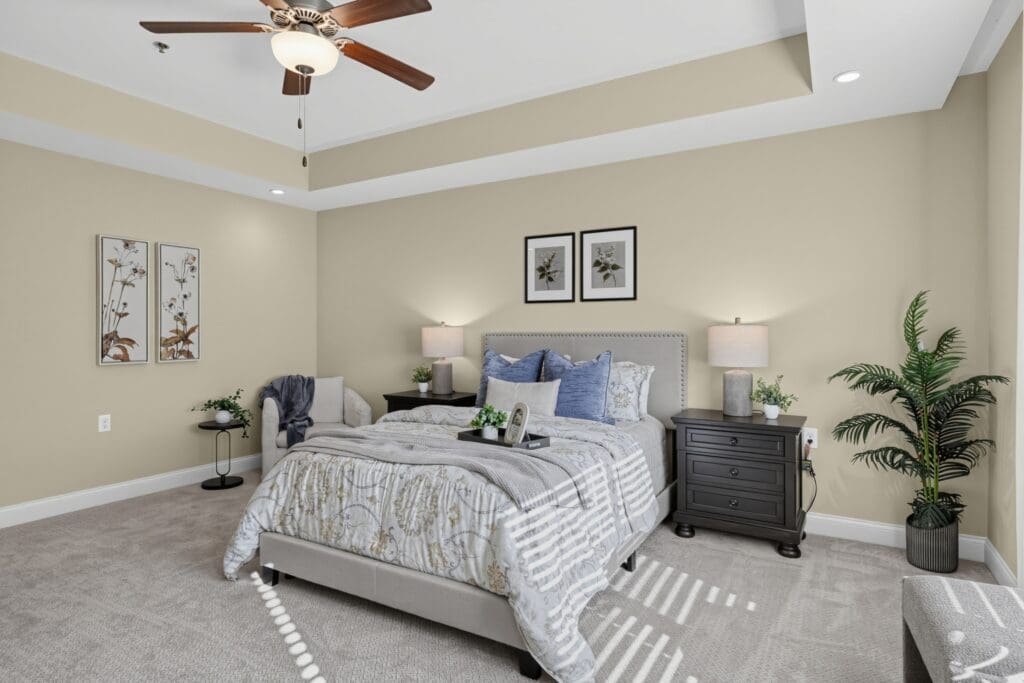 Spacious, elegantly appointed bedroom featuring soft lighting, stylish decor, and a cozy, inviting atmosphere.