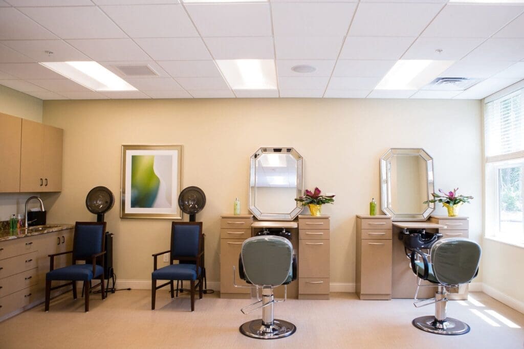 Bridgewater-Salon-2048x1365 - Grace Management Stylish salon with modern chairs, mirrors, and floral arrangements, creating an inviting space for personal care and pampering.
