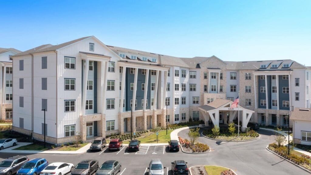 Modern senior living community featuring elegant architecture, spacious grounds, and vibrant landscaped courtyards.