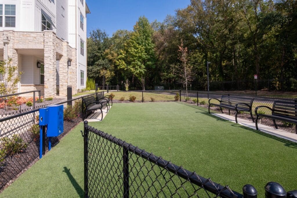 Lush green outdoor space with seating and vibrant landscaping, offering an inviting atmosphere for relaxation.