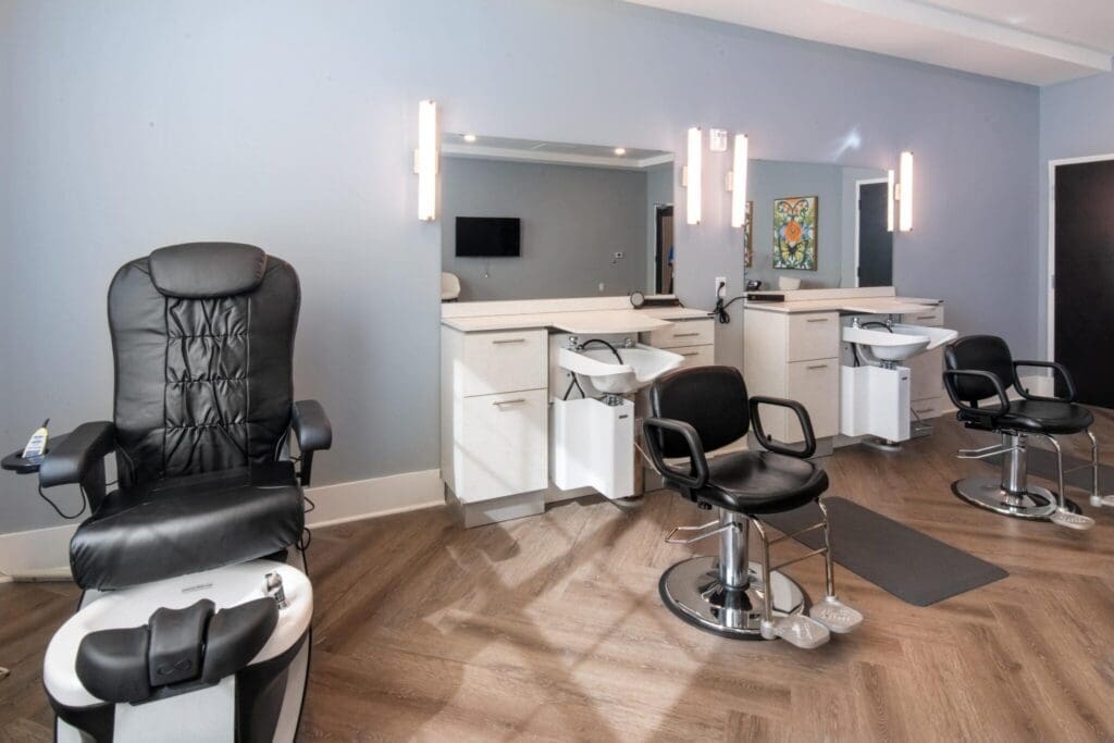 Sophisticated salon featuring elegant hair styling chairs, modern décor, and vibrant artistic accents for an upscale experience.