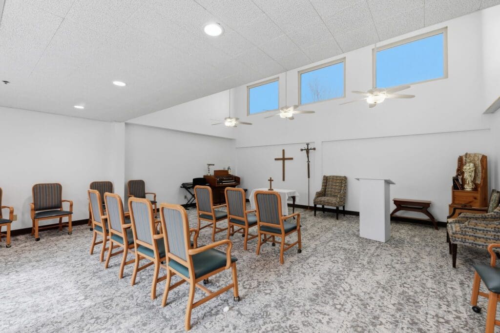 Chapel_NorthgatePark - Grace Management Serene gathering space featuring comfortable seating, a podium, and spiritual decor, perfect for community activities.