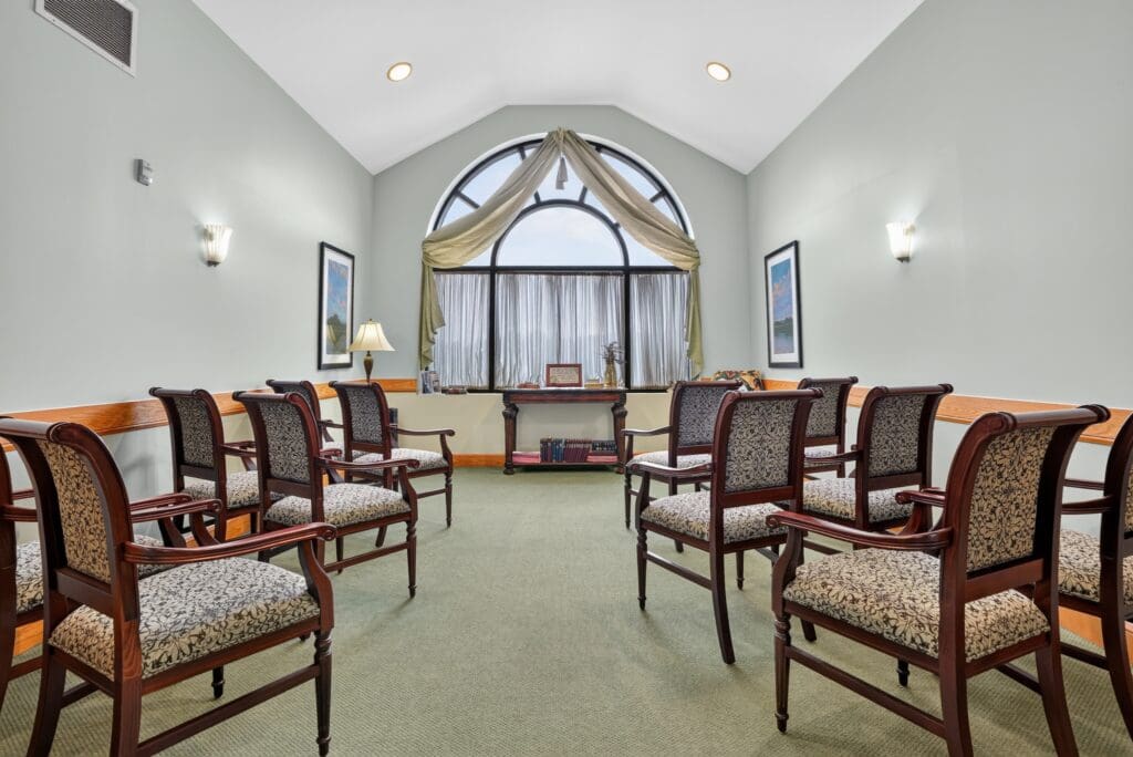 Inviting seating area featuring elegant chairs, soft lighting, and large windows, creating a welcoming atmosphere.