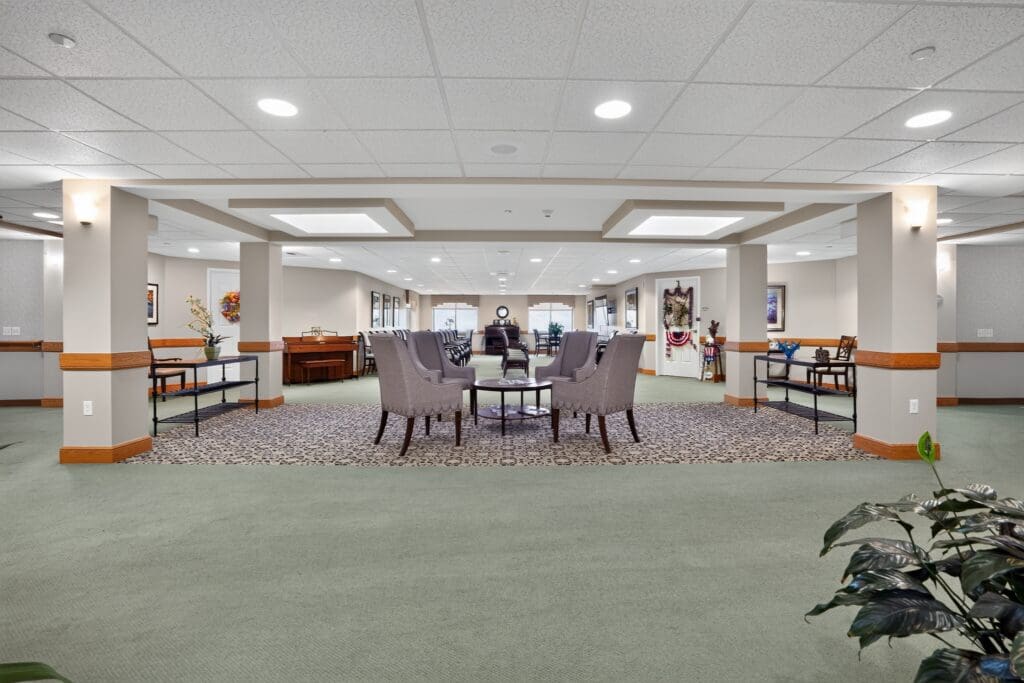 Welcoming common area featuring elegant seating, vibrant décor, and ample natural light, emphasizing a vibrant lifestyle.