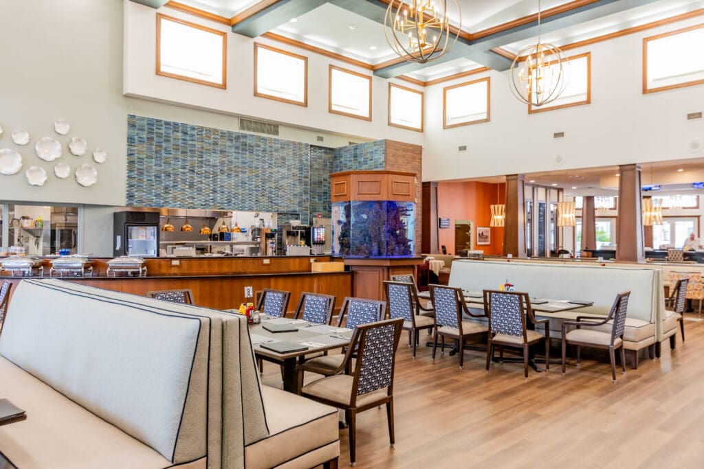Elegant dining area featuring modern decor, comfortable seating, and an open kitchen, inviting a vibrant community experience.