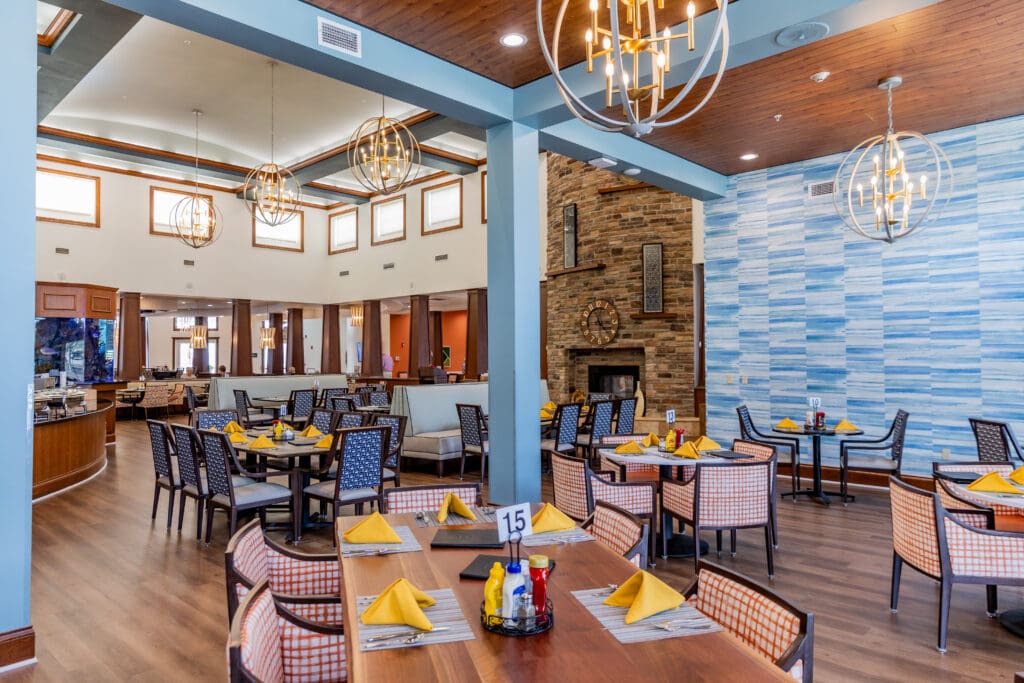 Elegant dining area featuring stylish furniture, ambient lighting, and vibrant decor, inviting a warm, social atmosphere.