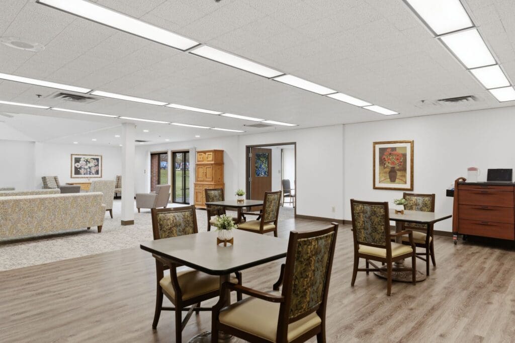 DiningRoom_NorthgatePark - Grace Management Spacious common area with elegant seating, dining tables, and large windows offering natural light and vibrant decor.