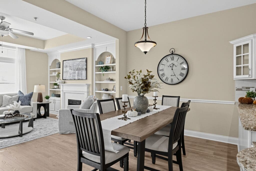 Sophisticated living space featuring a dining area, cozy seating, elegant decor, and warm natural light.