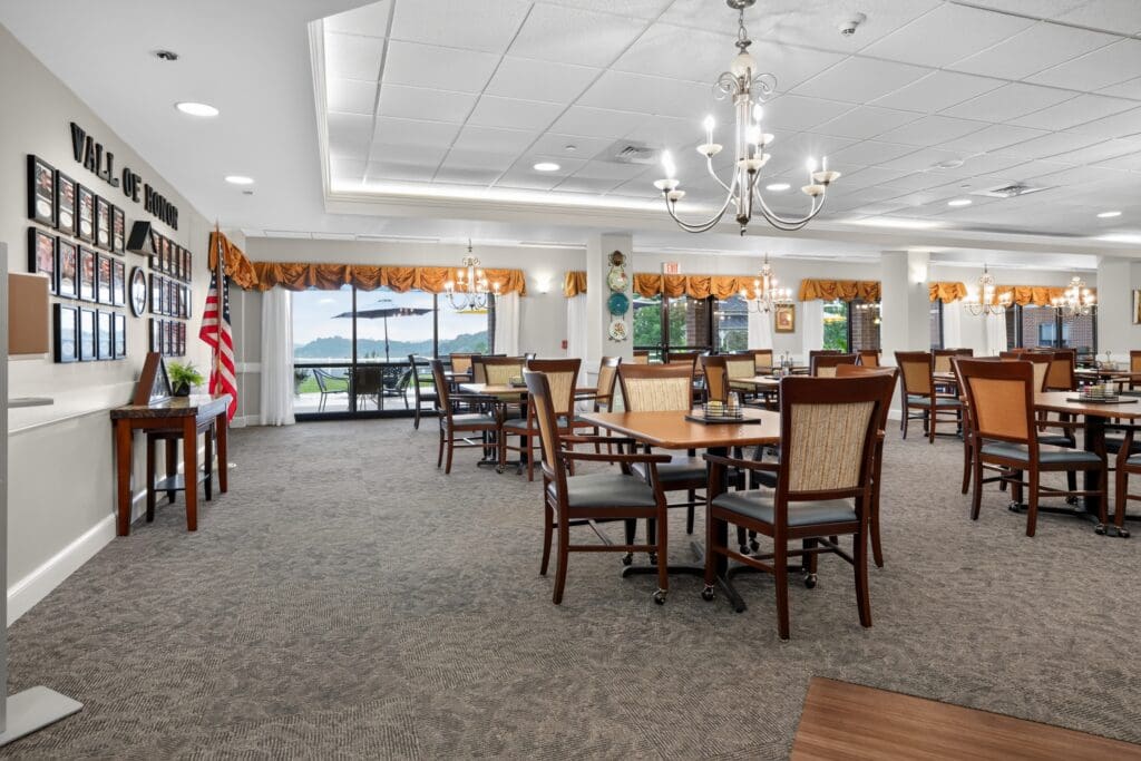 Elegant dining area featuring tables, comfortable chairs, and scenic views through large windows.